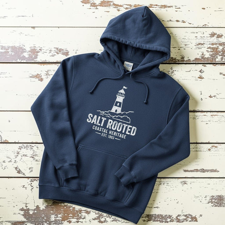 True Navy Salt Rooted lighthouse hoodie flat lay on weathered driftwood planks