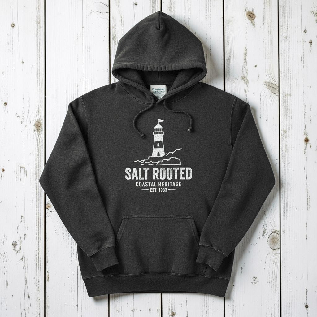 Pepper charcoal Salt Rooted lighthouse hoodie flat lay on weathered driftwood planks