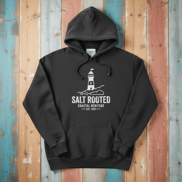 Pepper charcoal Salt Rooted lighthouse hoodie flat lay on weathered driftwood planks