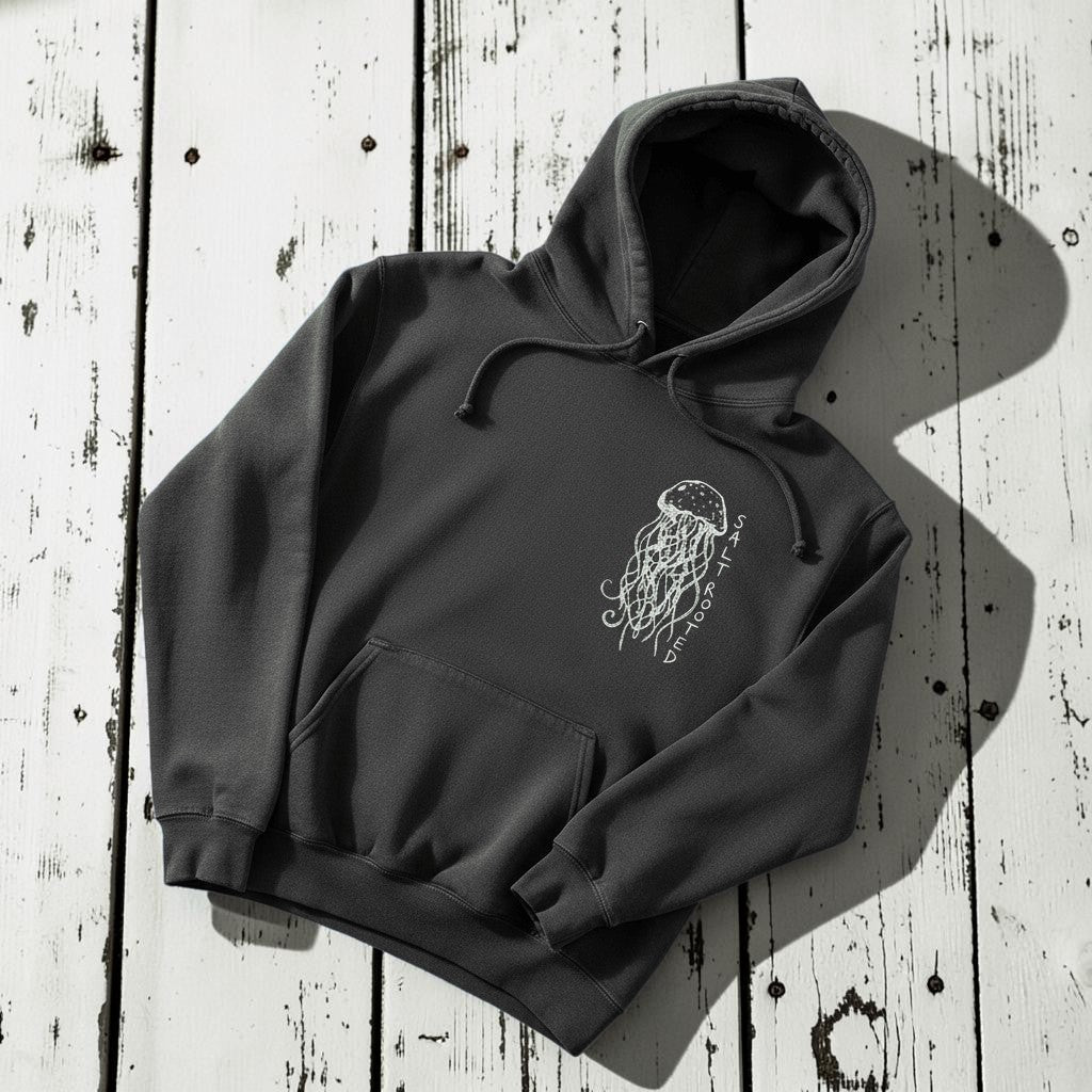 Salt Rooted Jellyfish Hoodie in Pepper Charcoal — front chest graphic with hand-drawn jellyfish on driftwood
