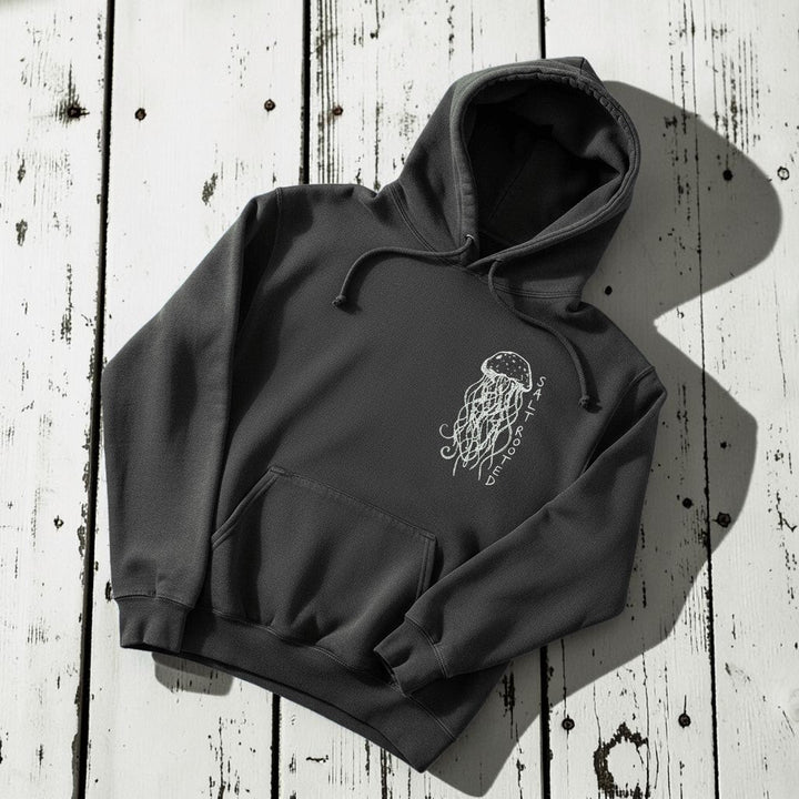 Salt Rooted Jellyfish Hoodie in Pepper Charcoal — front chest graphic with hand-drawn jellyfish on driftwood