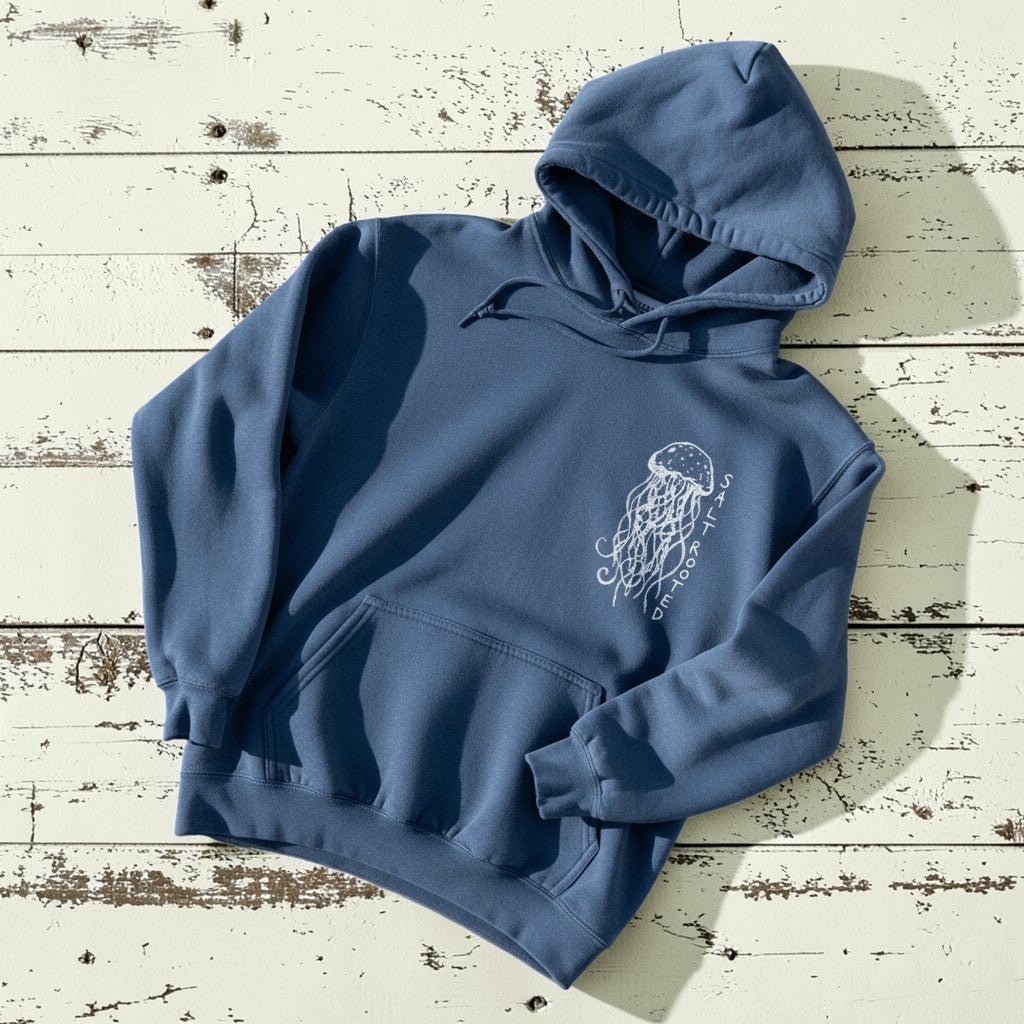 Salt Rooted Jellyfish Hoodie in Blue Jean — front chest graphic with hand-drawn jellyfish on driftwood