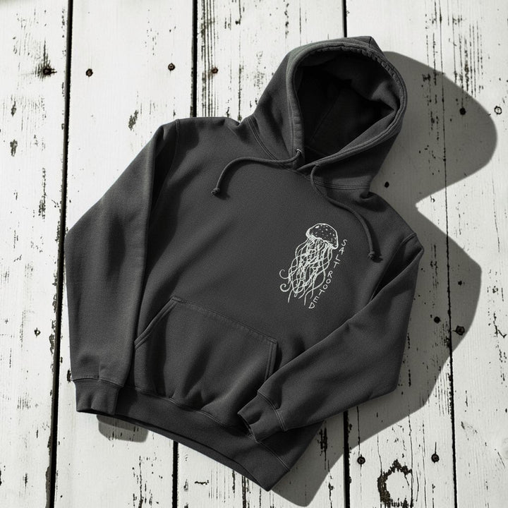 Salt Rooted Jellyfish Hoodie in Pepper Charcoal — front chest graphic with hand-drawn jellyfish on driftwood