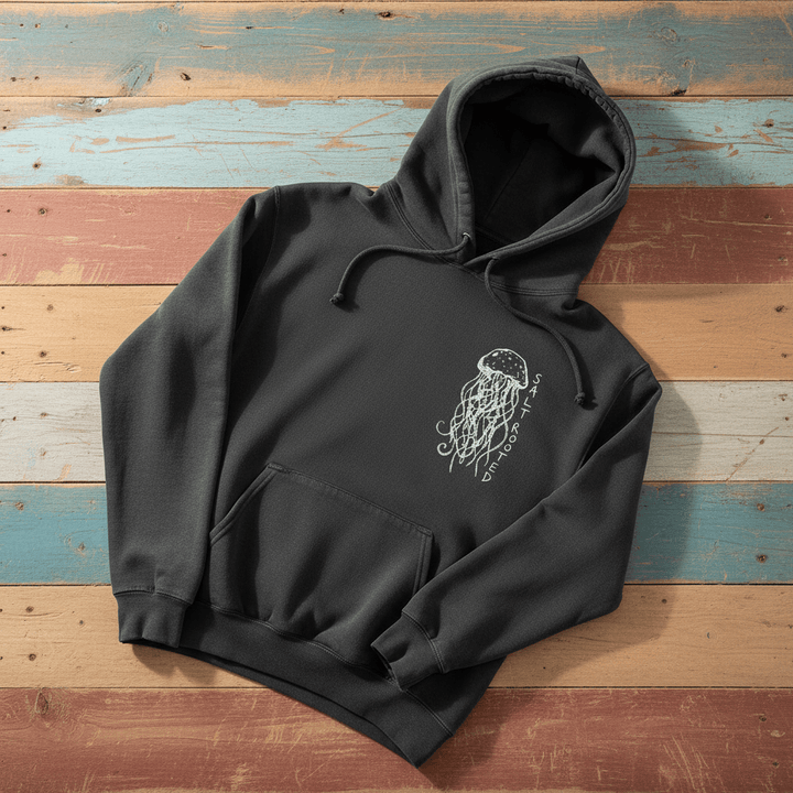 Salt Rooted Jellyfish Hoodie in Pepper Charcoal — front chest graphic with hand-drawn jellyfish on driftwood