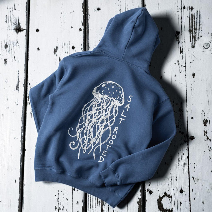 Salt Rooted Jellyfish Hoodie in Blue Jean — back graphic with hand-drawn jellyfish and SALT ROOTED lettering on driftwood