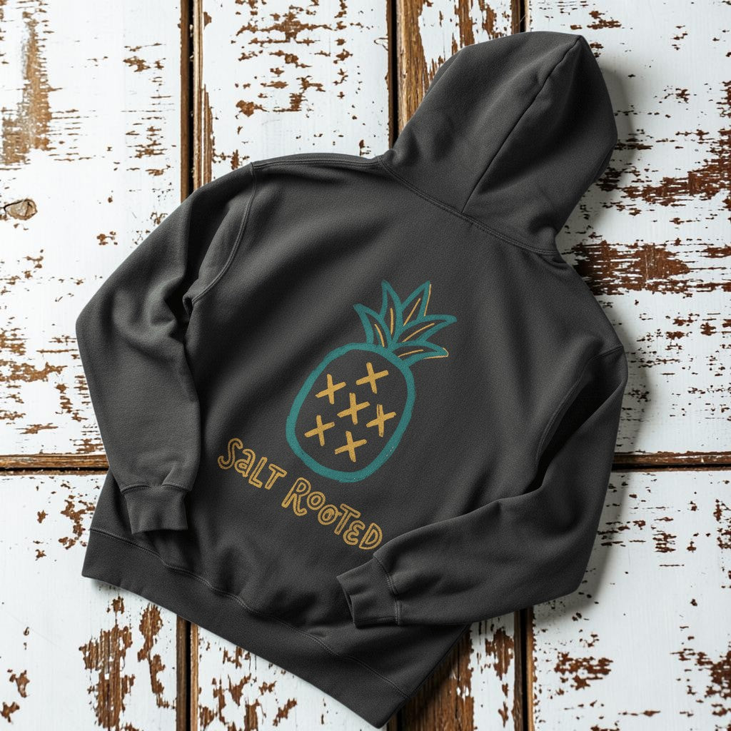 Salt Rooted Pineapple Hoodie in Pepper — back graphic with teal pineapple and SALT ROOTED lettering on driftwood