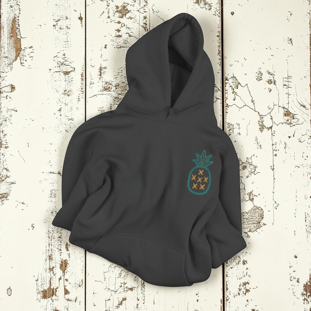 Salt Rooted Pineapple Hoodie in Pepper — front chest pineapple graphic on driftwood