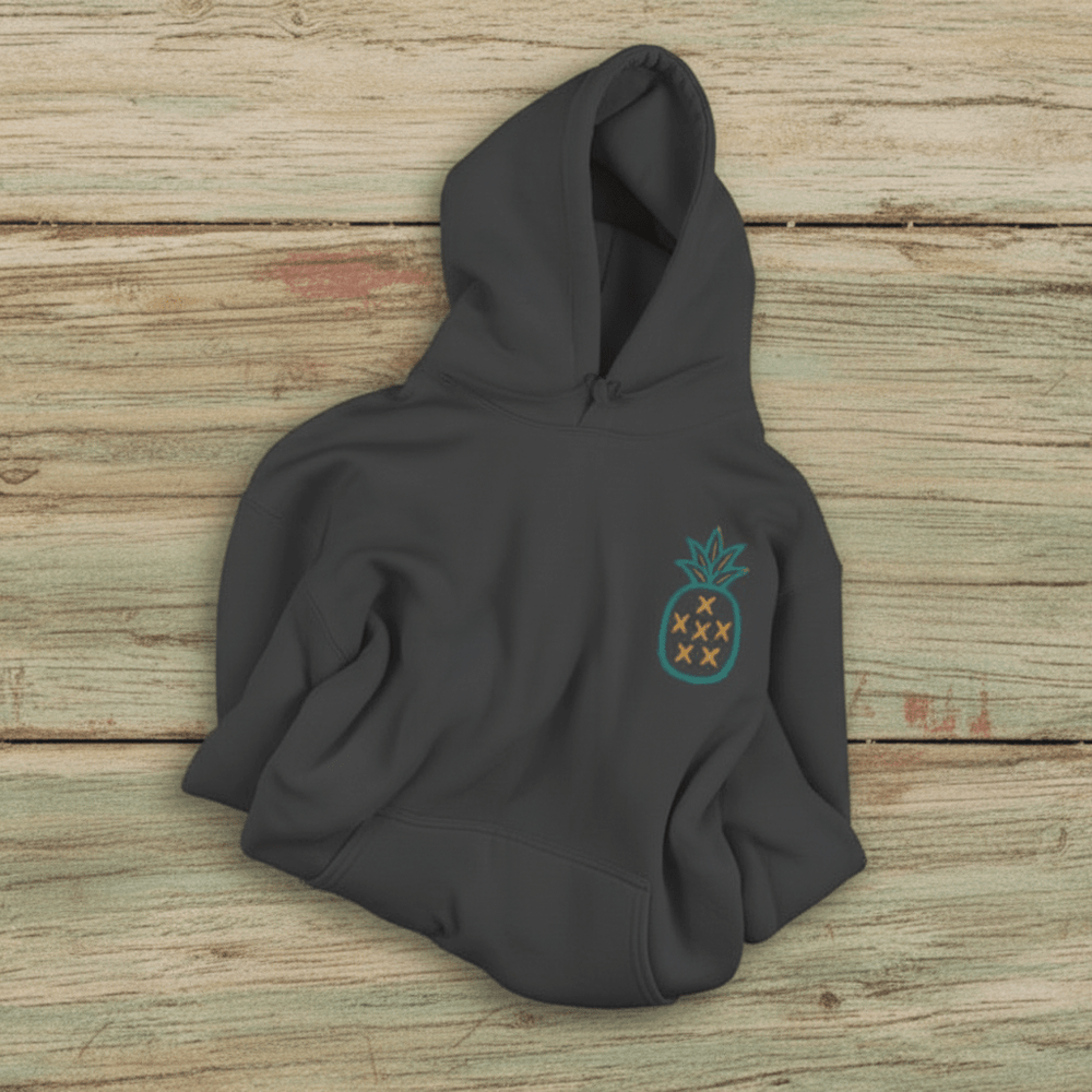Salt Rooted Pineapple Hoodie in Pepper — front chest pineapple graphic on driftwood