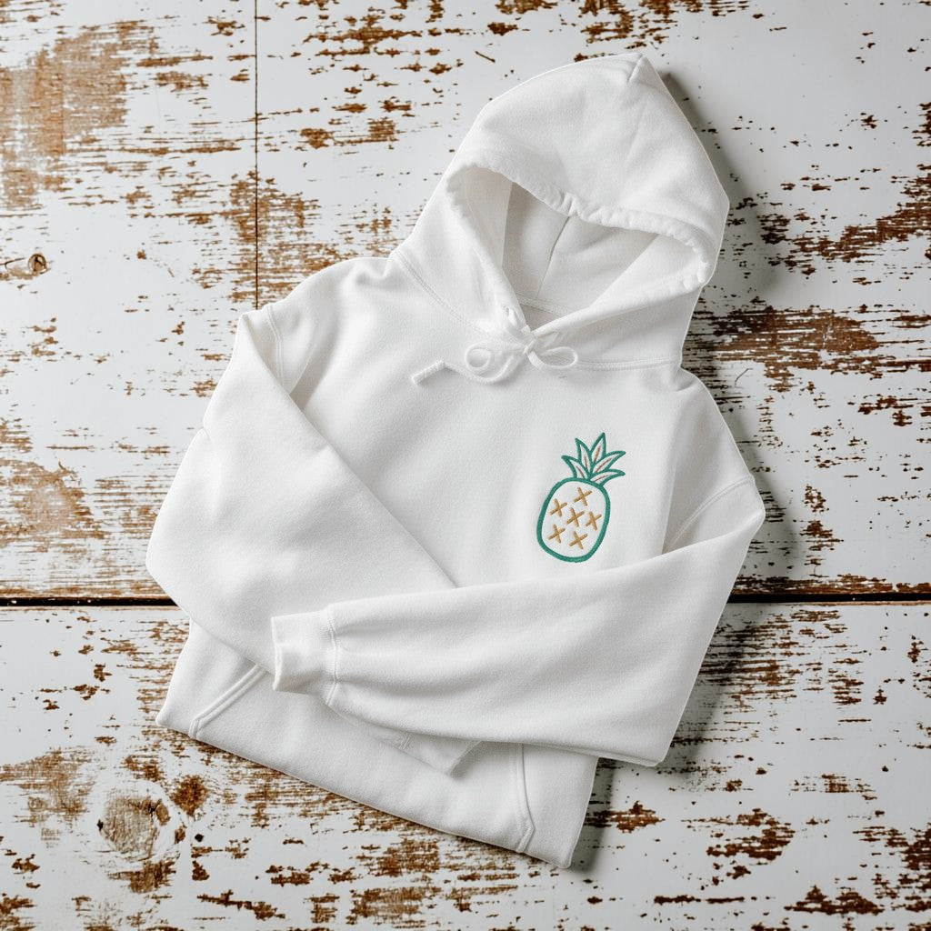 Salt Rooted Pineapple Hoodie in White — front chest pineapple graphic on driftwood