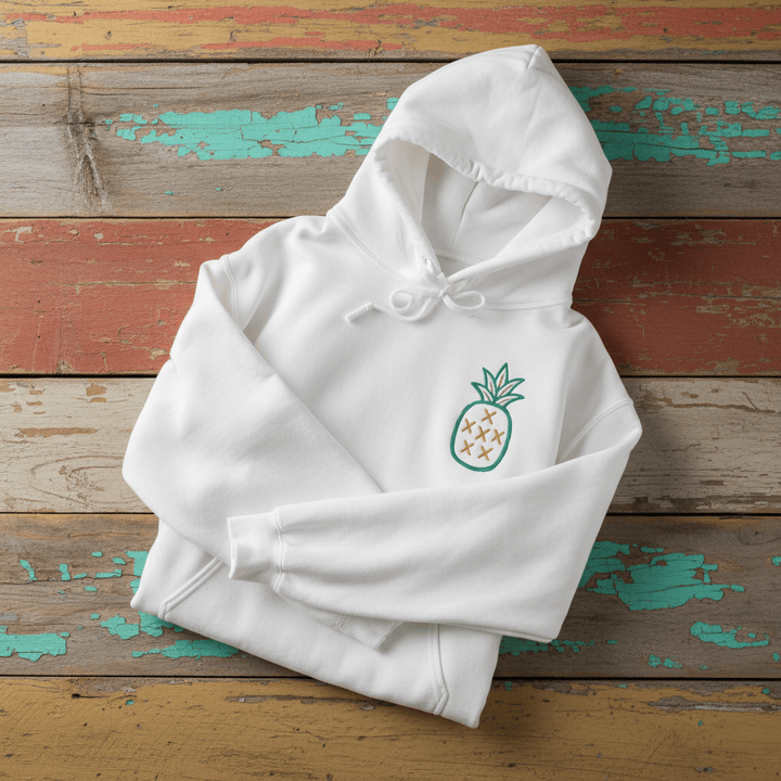 Salt Rooted Pineapple Hoodie in White — front chest pineapple graphic on driftwood