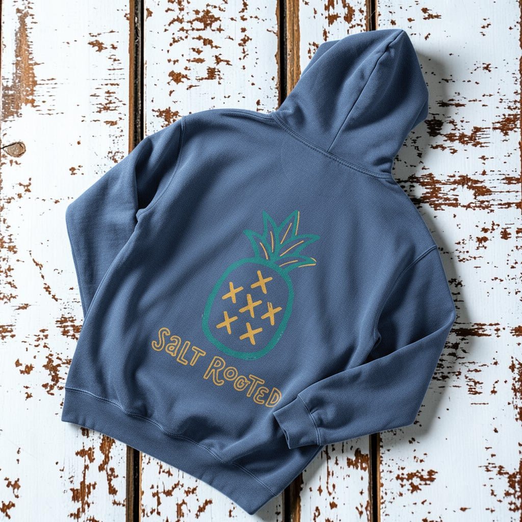 Salt Rooted Pineapple Hoodie in Steel Blue — back graphic with teal pineapple and SALT ROOTED lettering on driftwood