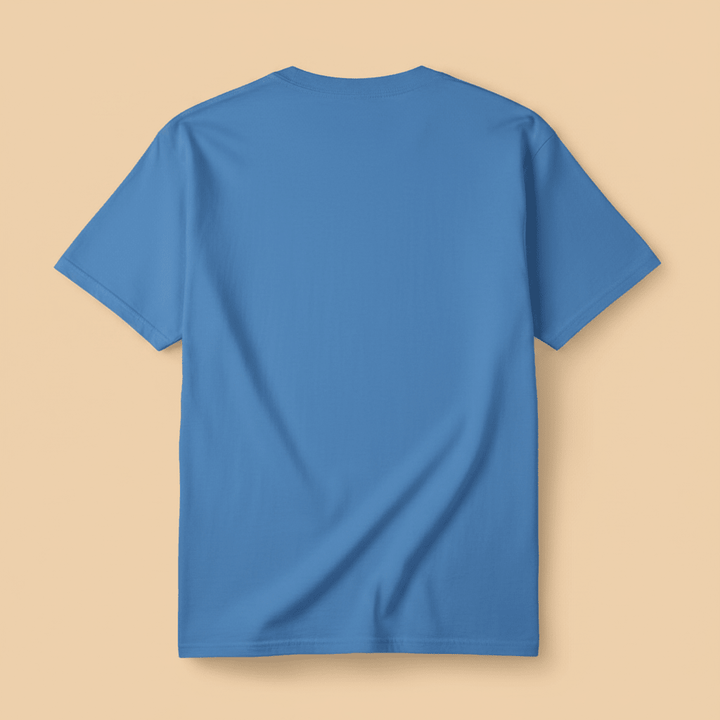 Saltwater Surf Club Tee in Bay Blue — plain back, warm sand studio background