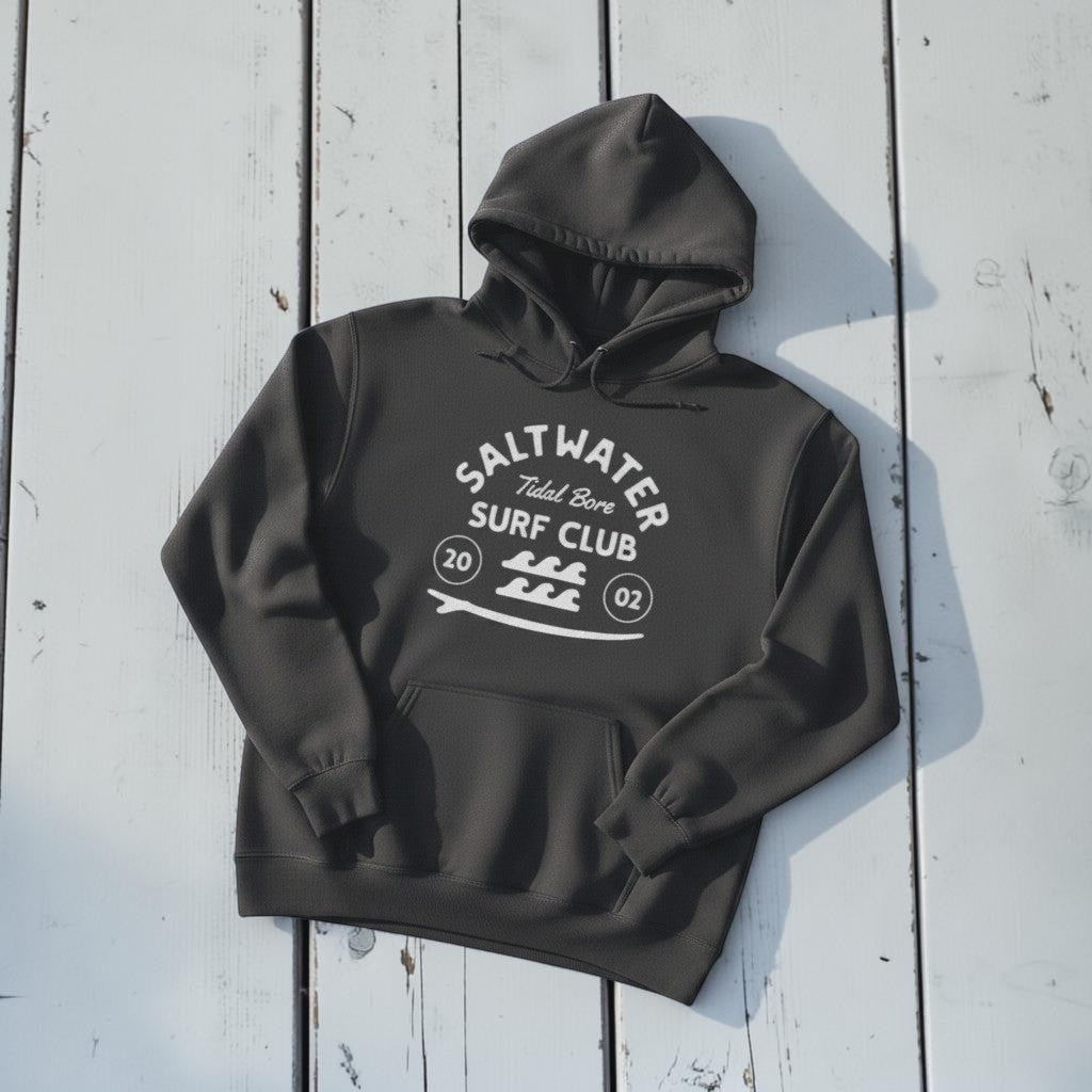 Saltwater Surf Club Hoodie in Pepper — front graphic, warm sand studio background