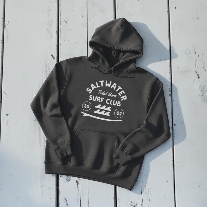 Saltwater Surf Club Hoodie in Pepper — front graphic, warm sand studio background