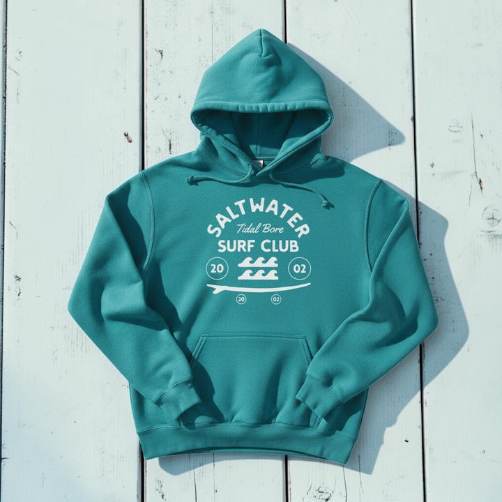 Saltwater Surf Club Hoodie in Seafoam — front graphic, warm sand studio background