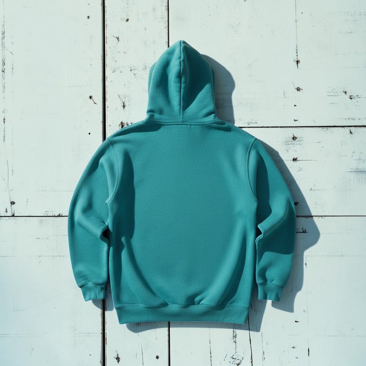 Saltwater Surf Club Hoodie in Seafoam — plain back, warm sand studio background
