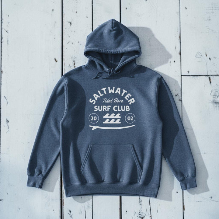 Saltwater Surf Club Hoodie in Denim — front graphic, warm sand studio background
