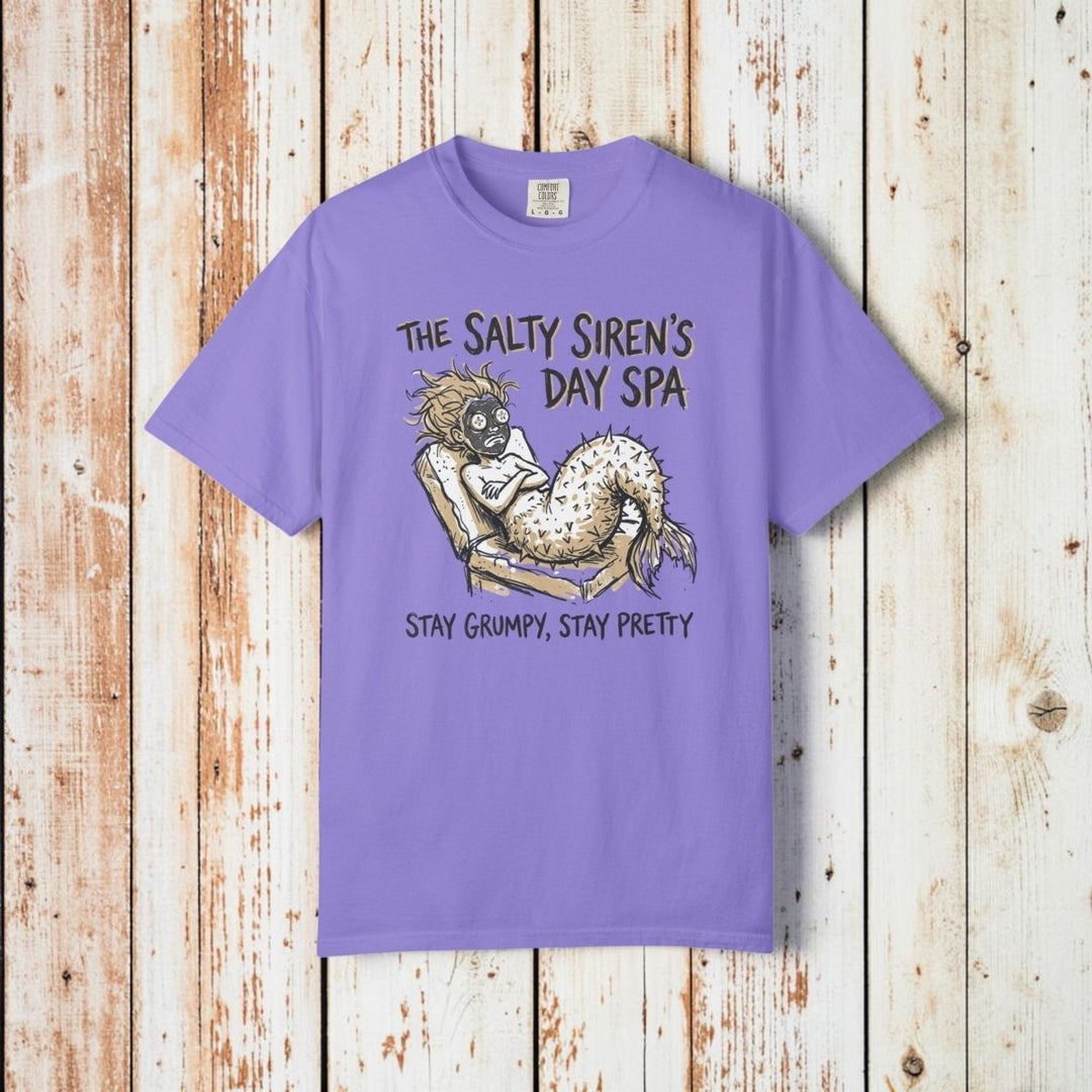 Purple t-shirt with a mermaid graphic and text on a white background