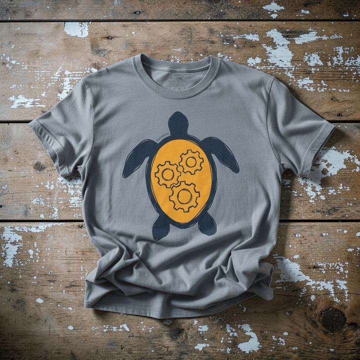 Sea Turtle Gear graphic t-shirt in Blue Jean casually tossed on a light sand-colored woven rug