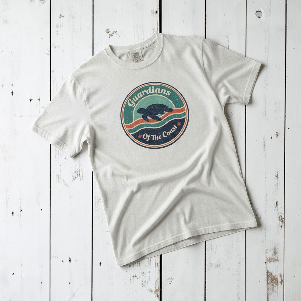 Sea Turtle Guardians of the Coast white garment-dyed tee on faded driftwood planks