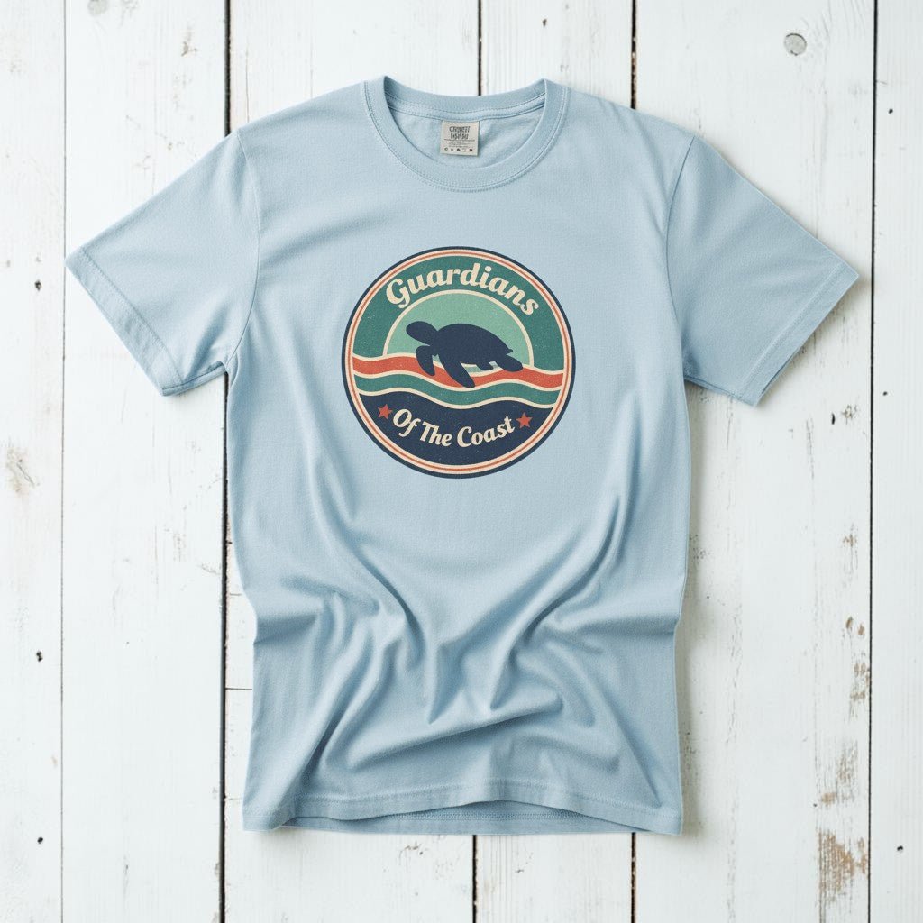 Sea Turtle Guardians of the Coast chambray garment-dyed tee on faded driftwood planks