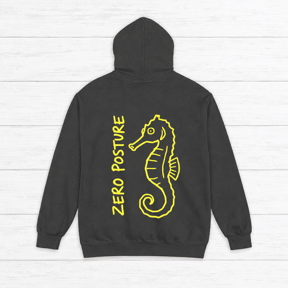 Pepper hoodie back with neon-yellow ZERO POSTURE lettering and matching seahorse art, on whitewashed boards.