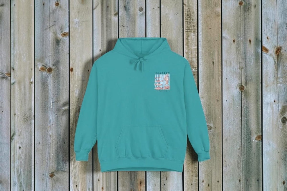 Teal hoodie with a small graphic on the chest against a white background