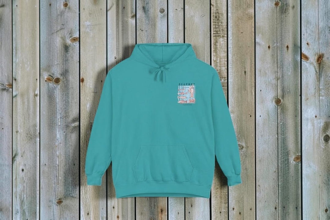 Teal hoodie with a small graphic on the chest against a white background