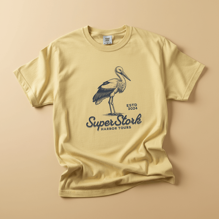 Super Stork Tee in Banana Yellow — front graphic, warm sand studio background