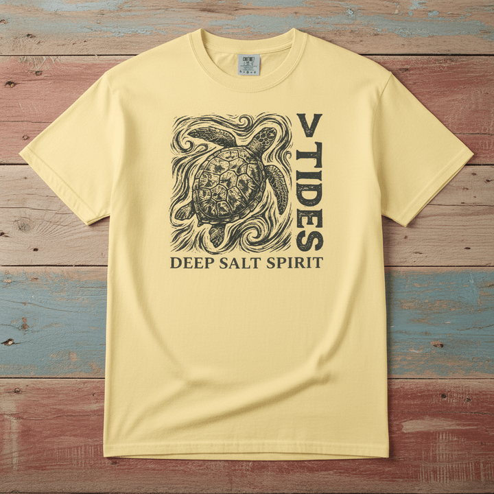 Flat lay - yellow V Tides Deep Salt Spirit tee on weathered driftwood planks