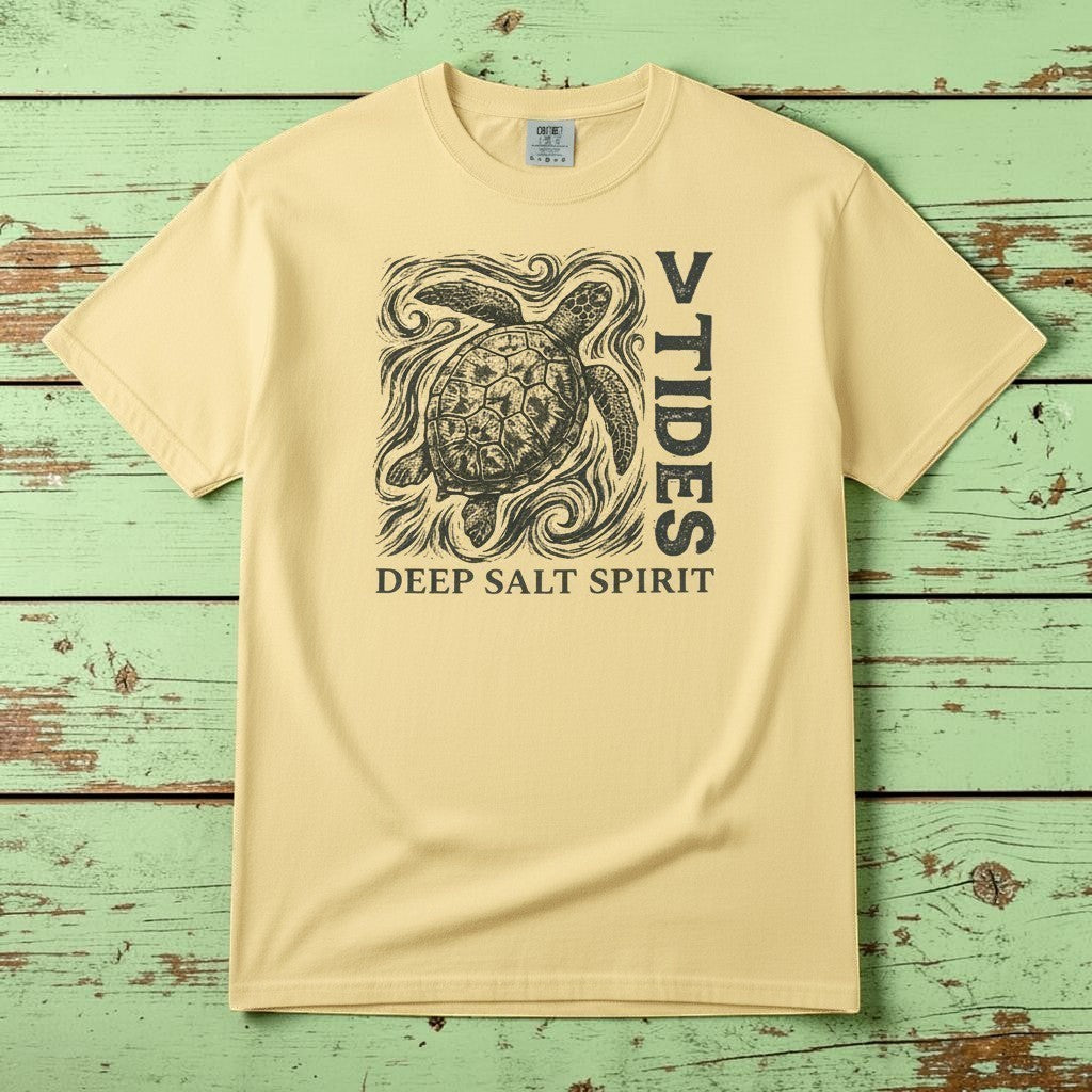 Flat lay - yellow V Tides Deep Salt Spirit tee on weathered driftwood planks