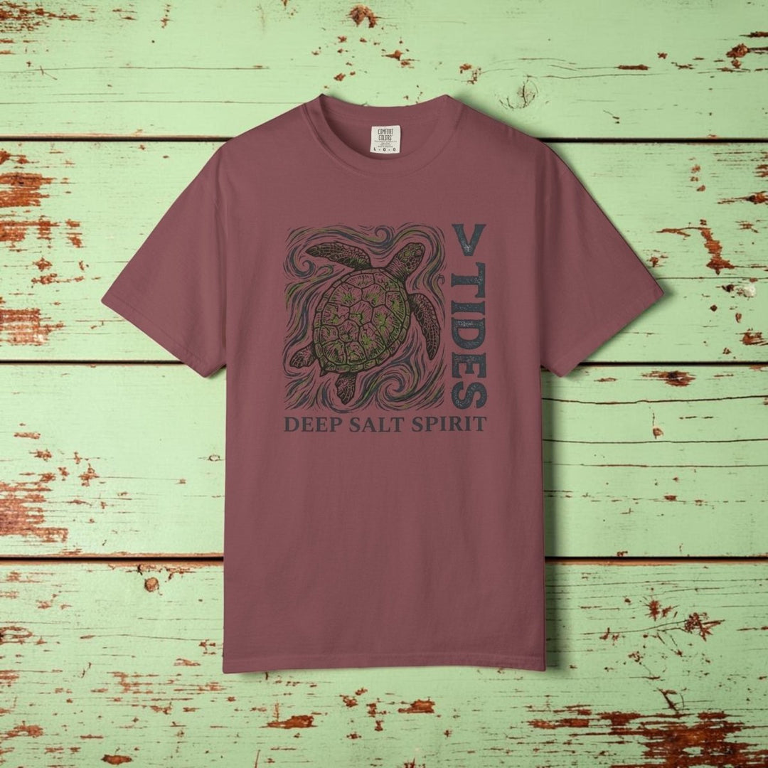 Maroon t-shirt with turtle graphic and text on a white background