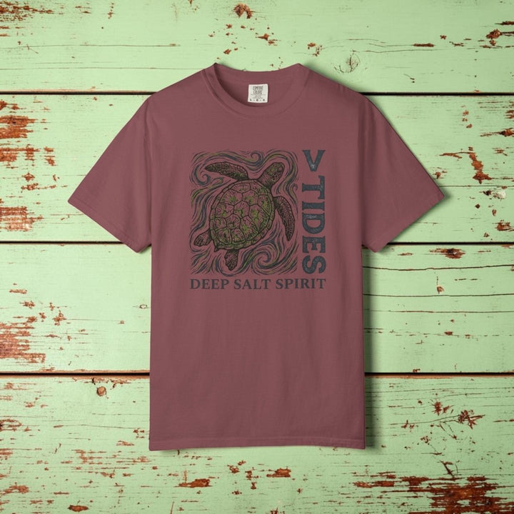 Maroon t-shirt with turtle graphic and text on a white background