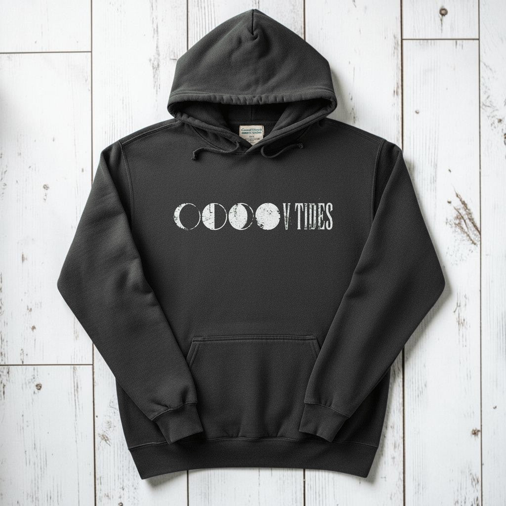 Pepper charcoal V Tides Moon Phases hoodie flat lay on weathered driftwood planks