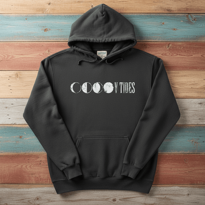 Pepper charcoal V Tides Moon Phases hoodie flat lay on weathered driftwood planks