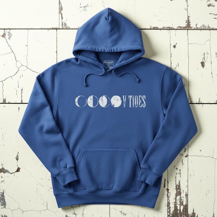 Flo Blue V Tides Moon Phases hoodie flat lay on weathered driftwood planks