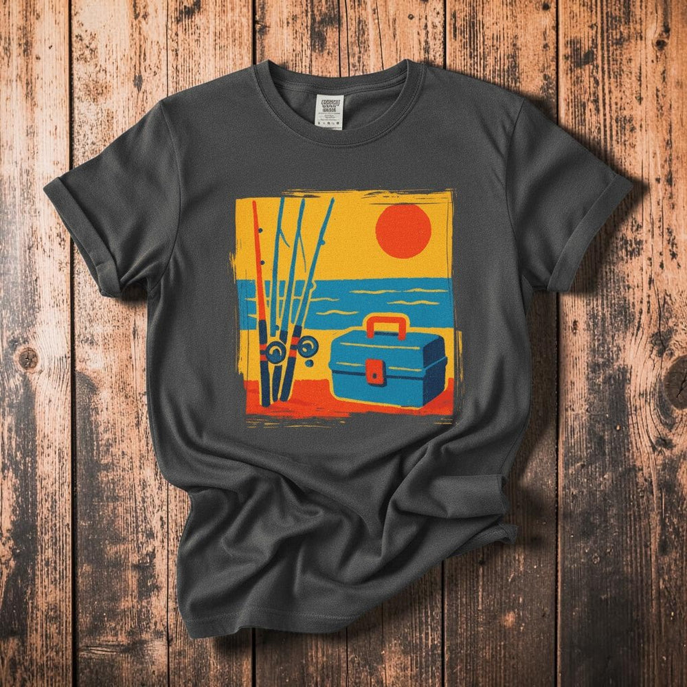 Vintage Tackle Box Sunset graphite garment-dyed tee on faded driftwood planks