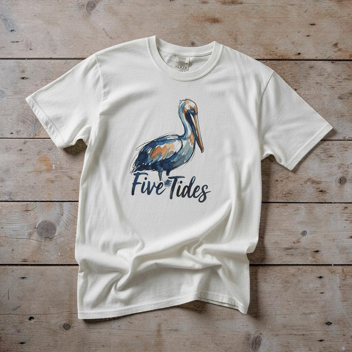 Watercolor Pelican white garment-dyed tee casually tousled on rustic reclaimed wood