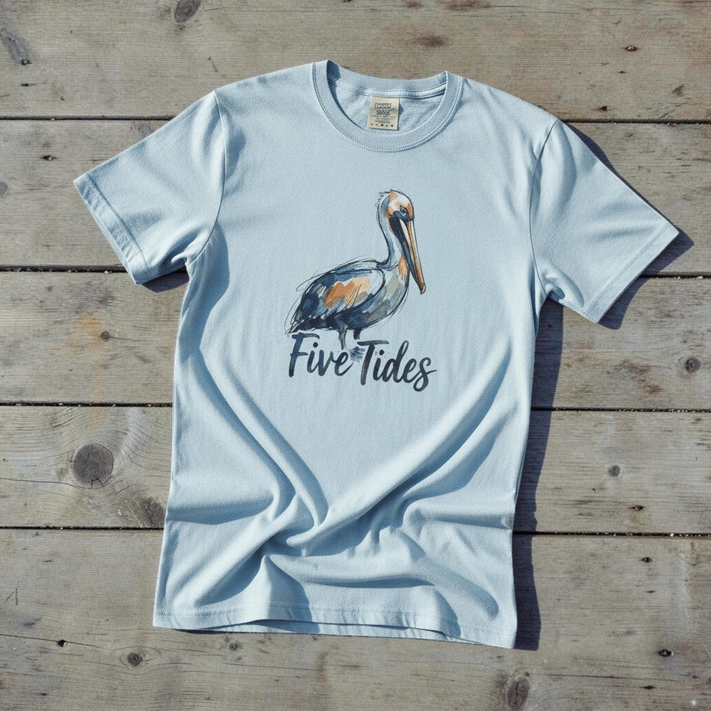 Watercolor Pelican chambray garment-dyed tee casually tousled on rustic reclaimed wood