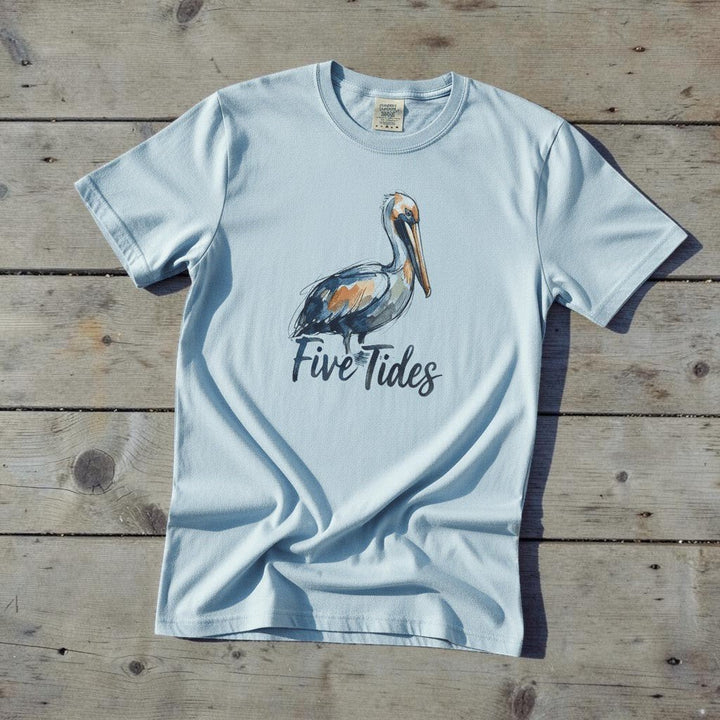 Watercolor Pelican chambray garment-dyed tee casually tousled on rustic reclaimed wood